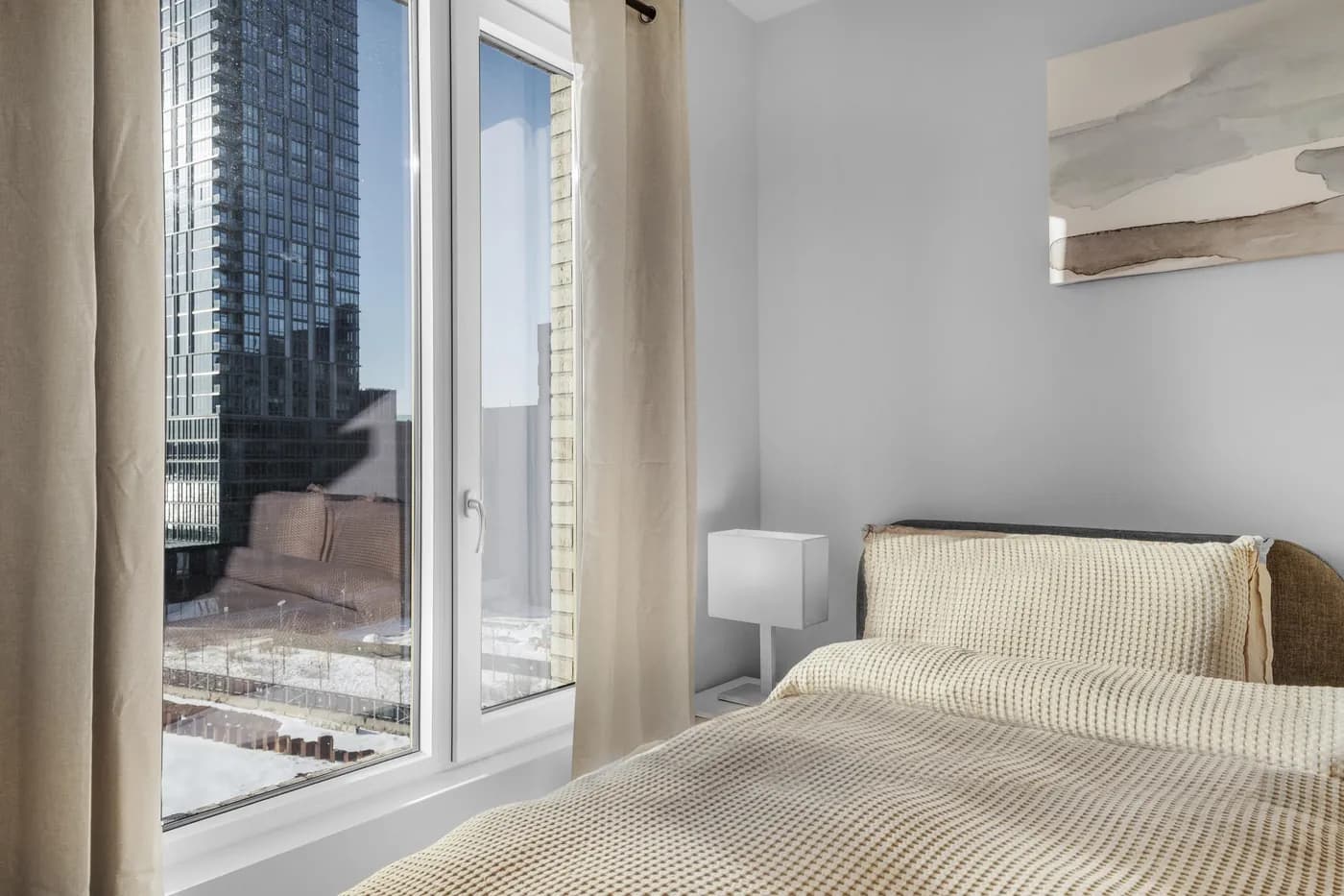 Furnished bedroom with city views in a Waypost Brooklyn residence.